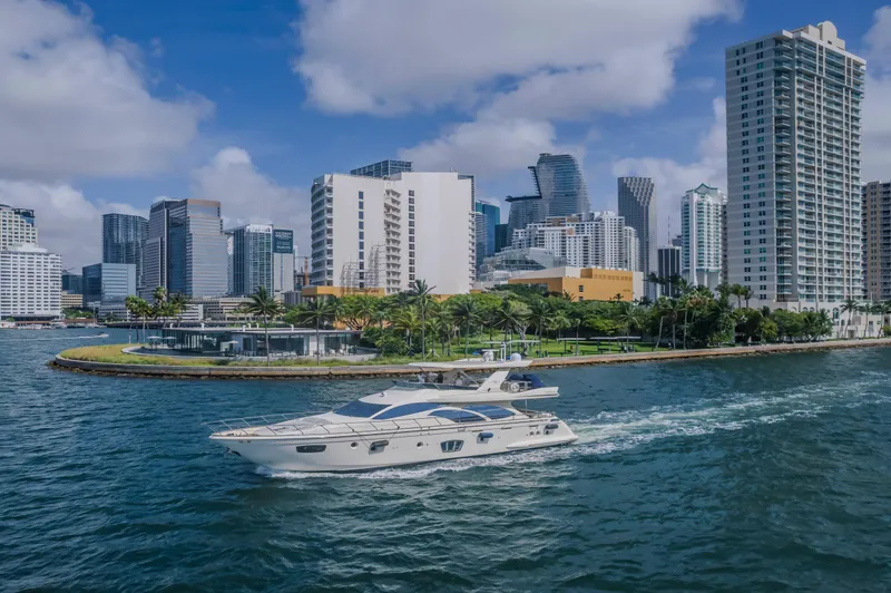 Slide: The Image of 2008 Azimut Flybridge yacht cruising near a city skyline with modern skyscrapers. - 30