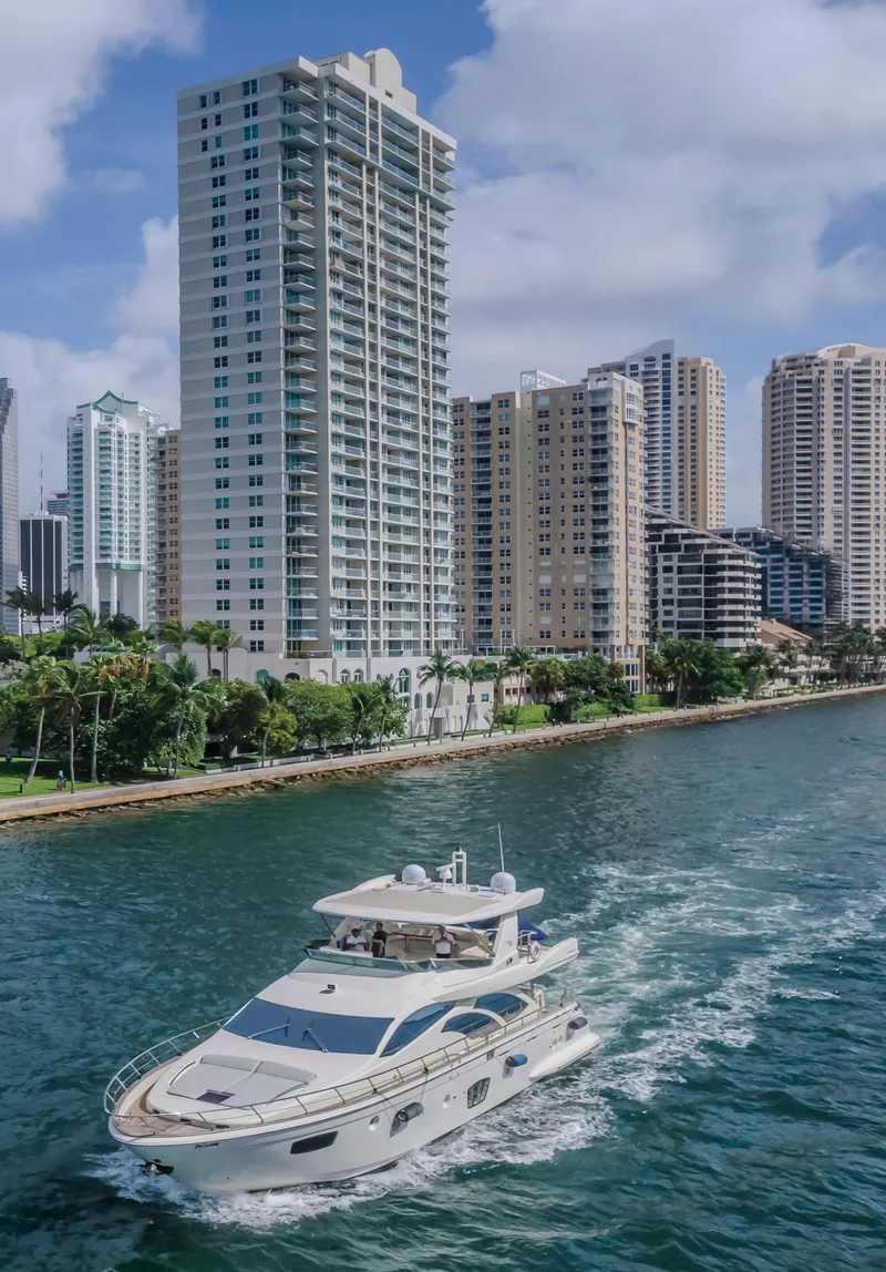 Slide: The Image of 2008 Azimut Flybridge yacht cruising near urban waterfront skyscrapers. - 31