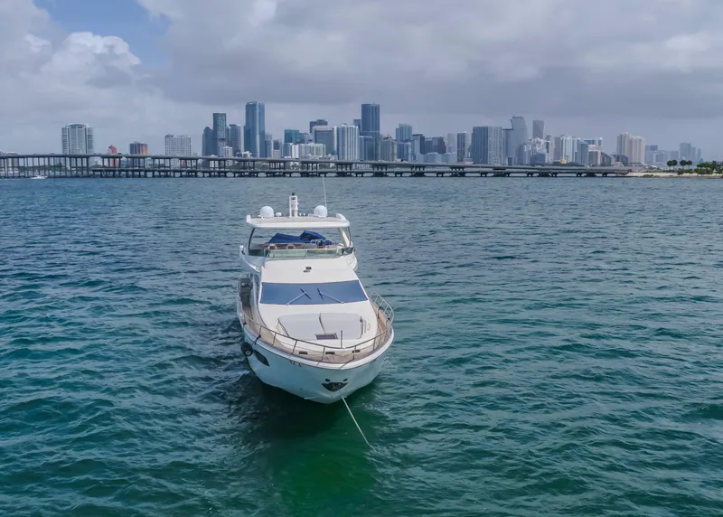 Slide: The Image of Luxury 2008 Azimut Flybridge yacht anchored with city skyline backdrop. - 4