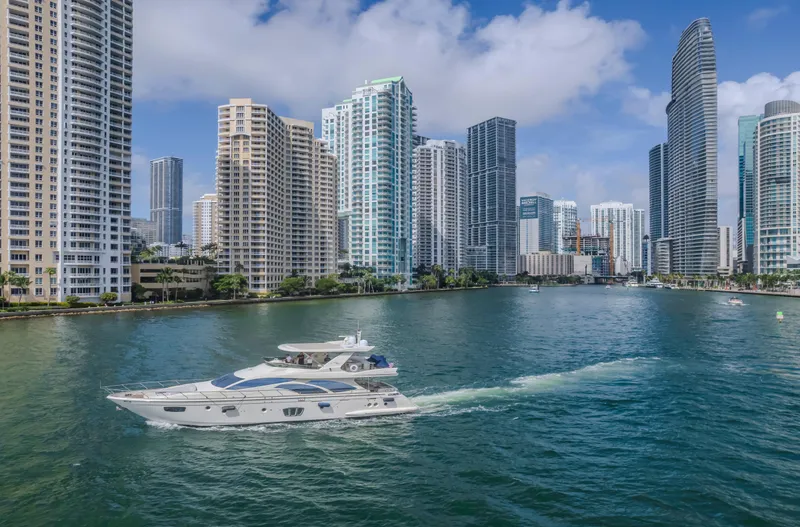 Slide: The Image of Azimut Flybridge 2008 yacht cruising in a cityscape with tall buildings and blue sky. - 40