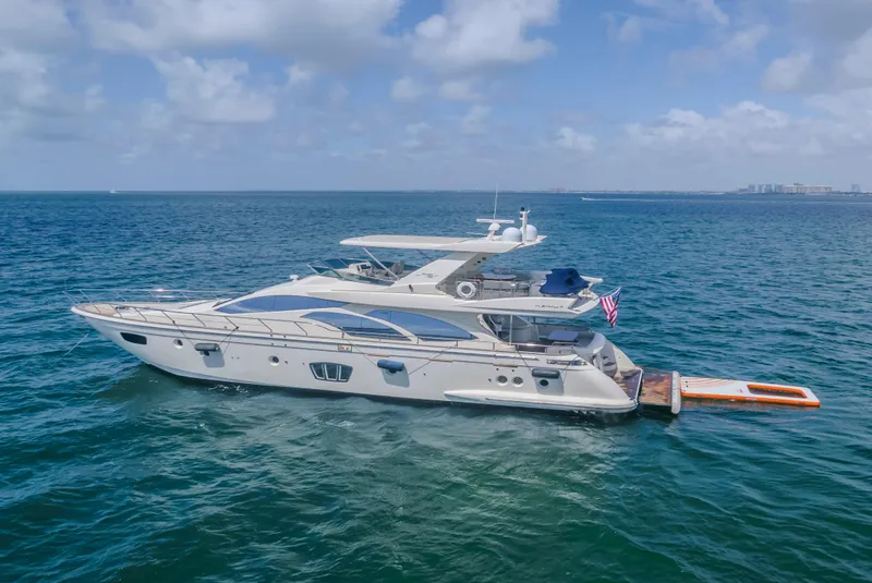 Slide: The Image of 2008 Azimut Flybridge yacht cruising on open sea under blue sky. - 5