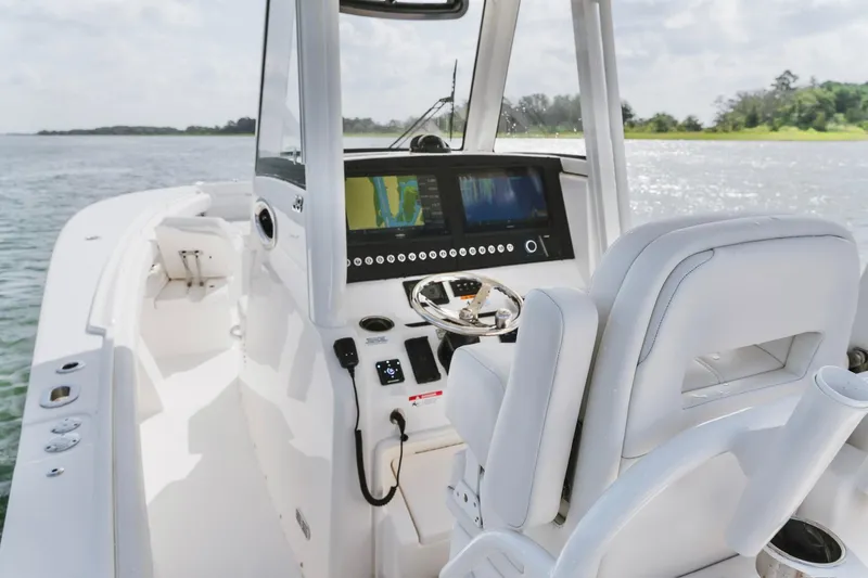 Slide: The Image of 2025 Regulator 28 boat cockpit with modern navigation system and comfortable seating. - 11