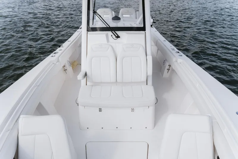 Slide: The Image of 2025 Regulator 28 boat interior with white seating on open water. - 13