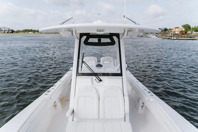 Slide: The Image of 2025 Regulator 28 boat on water, showcasing sleek design and spacious seating. - 16