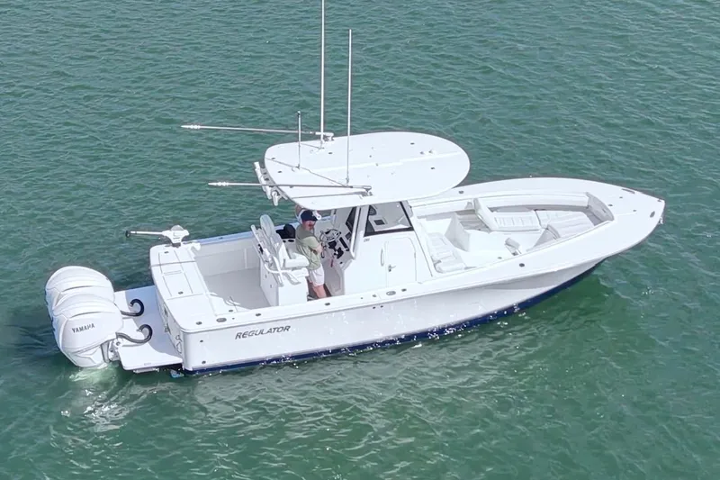 Slide: The Image of 2025 Regulator 28 boat on water, featuring twin Yamaha engines and spacious deck. - 5