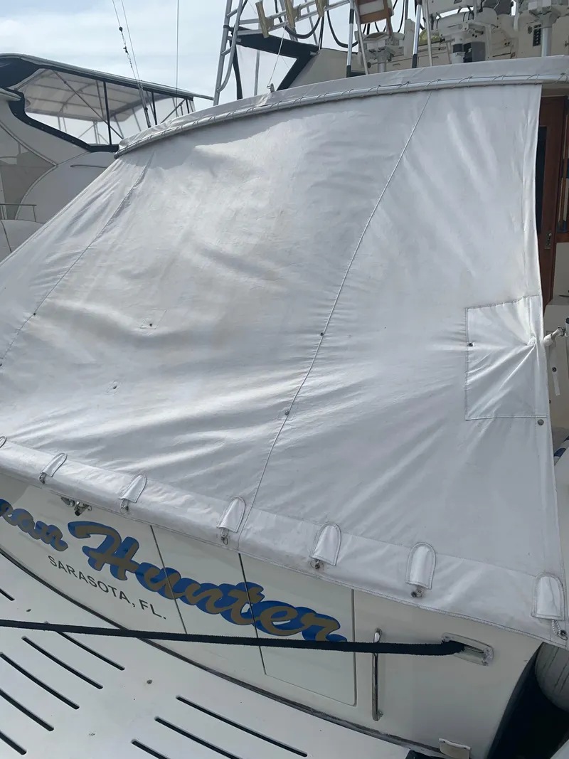 Slide: The Image of 1985 Ocean Yachts 55 Super Sport docked with cover in Sarasota, FL. - 19