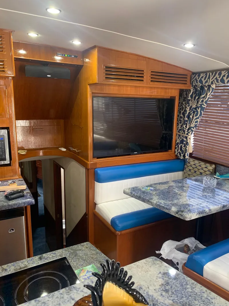 Slide: The Image of Interior of 1985 Ocean Yachts 55 Super Sport with blue and white seating, granite countertops. - 26