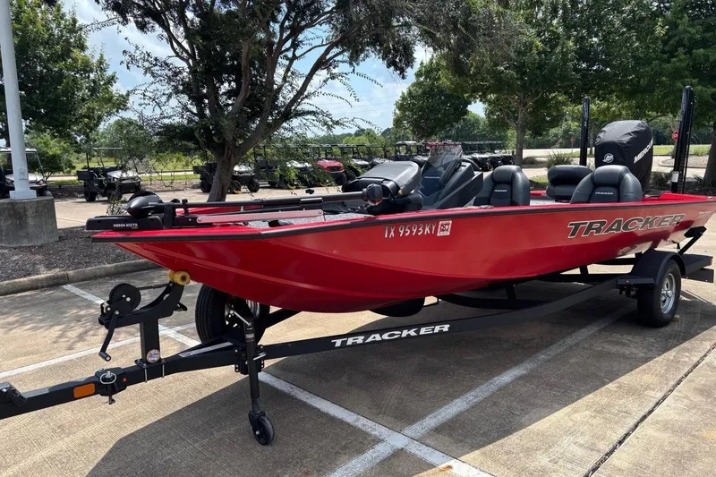 The Image of 2026 Tracker Pro Team 190 TX boat in vibrant red on a trailer, parked outdoors. - 0