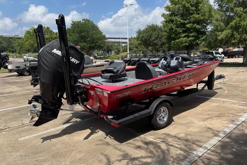 Slide: The Image of 2026 Tracker Pro Team 190 TX boat with Mercury engine in parking lot. - 2