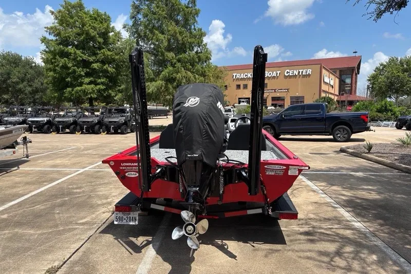 Slide: The Image of 2026 Tracker Pro Team 190 TX boat at dealership parking lot, rear view. - 3