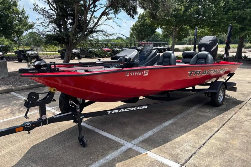 Slide: The Image of 2026 Tracker Pro Team 190 TX boat in vibrant red on a trailer, parked outdoors. - 5