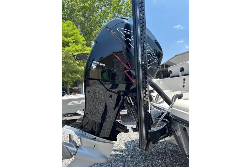 Slide: The Image of 2020 Blackwood 270 LXF boat with Mercury outboard motor, parked outdoors. - 13