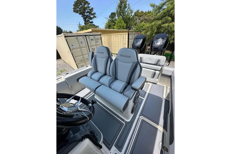 Slide: The Image of 2020 Blackwood 270 LXF boat interior with dual seats and steering wheel. - 19