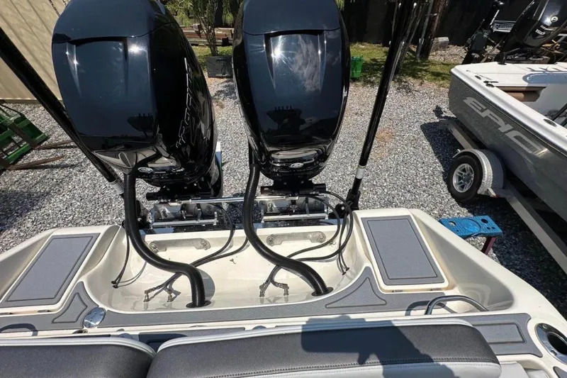 Slide: The Image of 2020 Blackwood 270 LXF boat with dual outboard engines, parked on gravel. - 6