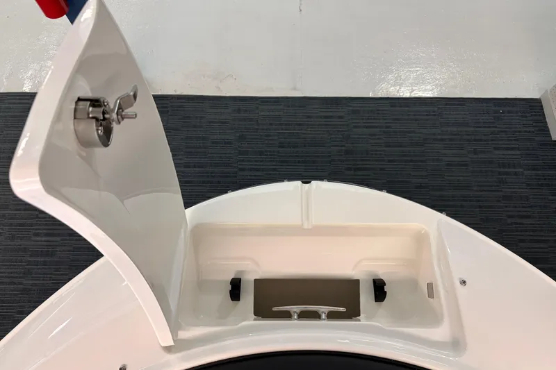 Slide: The Image of Open storage compartment on 2026 Sea Ray 21 SPX boat, featuring a secure latch. - 13