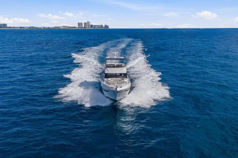 Slide: The Image of 2026 Princess F65 yacht cruising on open blue ocean with city skyline in background. - 13