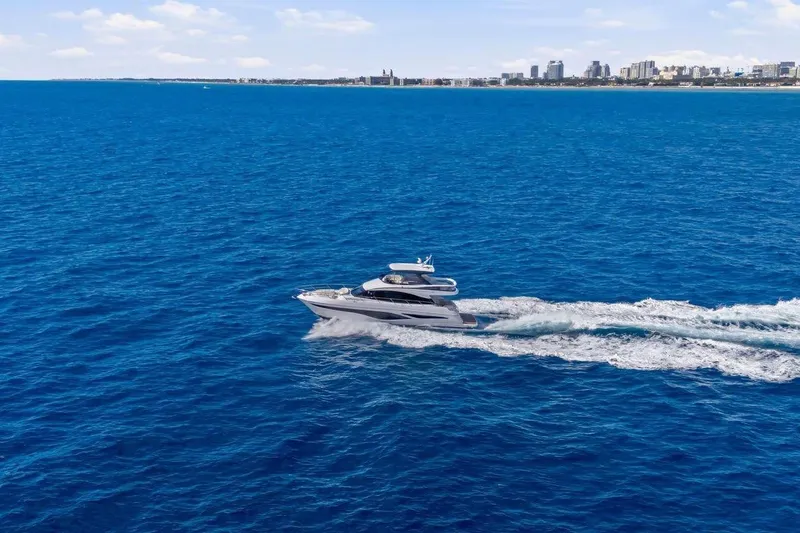 Slide: The Image of Luxury yacht Princess F65 2026 cruising on open sea near coastal city. - 14