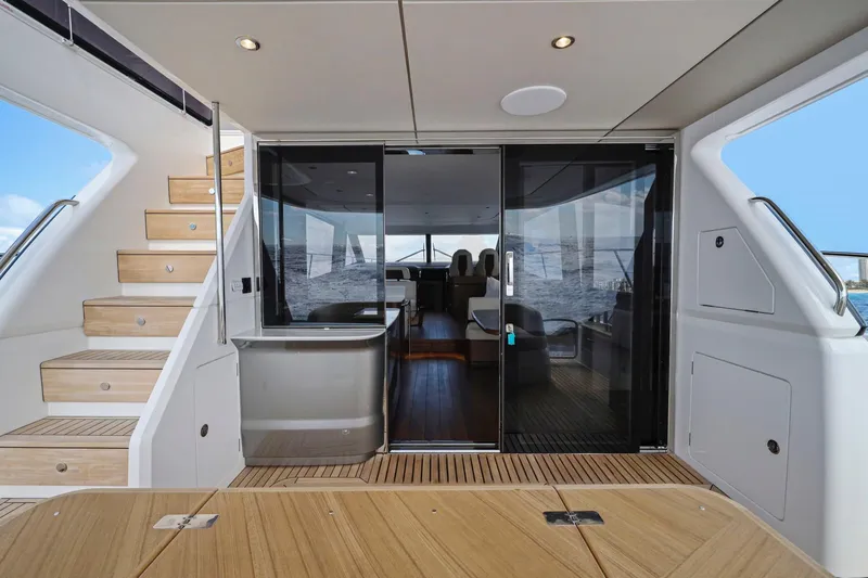Slide: The Image of Luxurious 2026 Princess F65 yacht interior with wooden stairs and glass doors. - 27