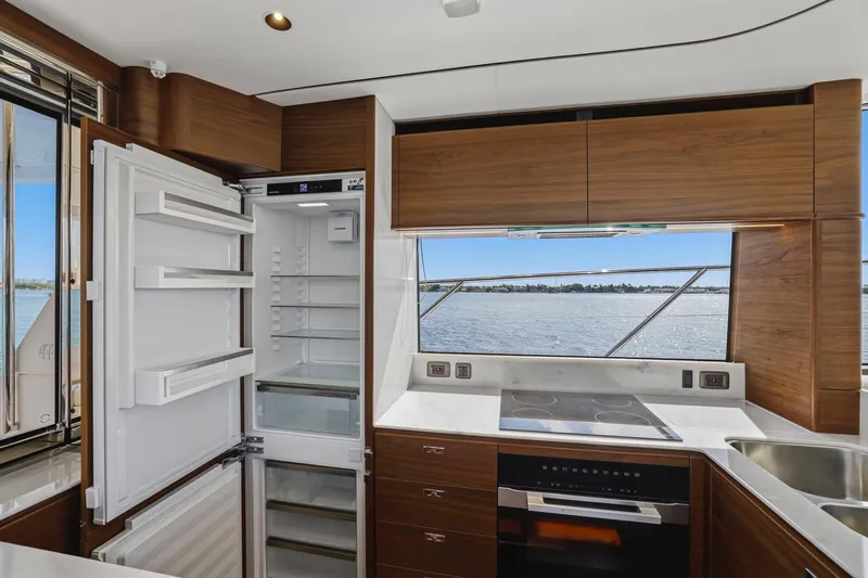 Slide: The Image of Modern yacht kitchen interior with open fridge, stove, and ocean view; Princess F65, 2026 model. - 37