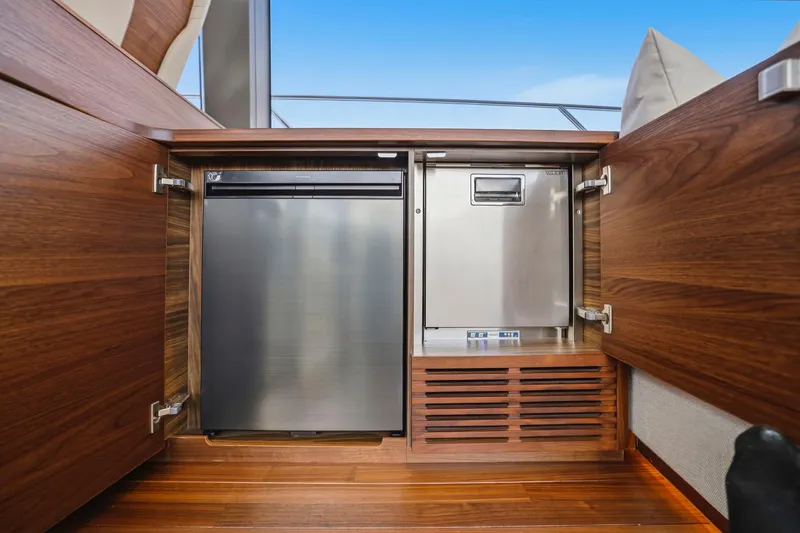 Slide: The Image of Luxury yacht Princess F65 2026 interior with sleek wooden cabinetry and modern appliances. - 38