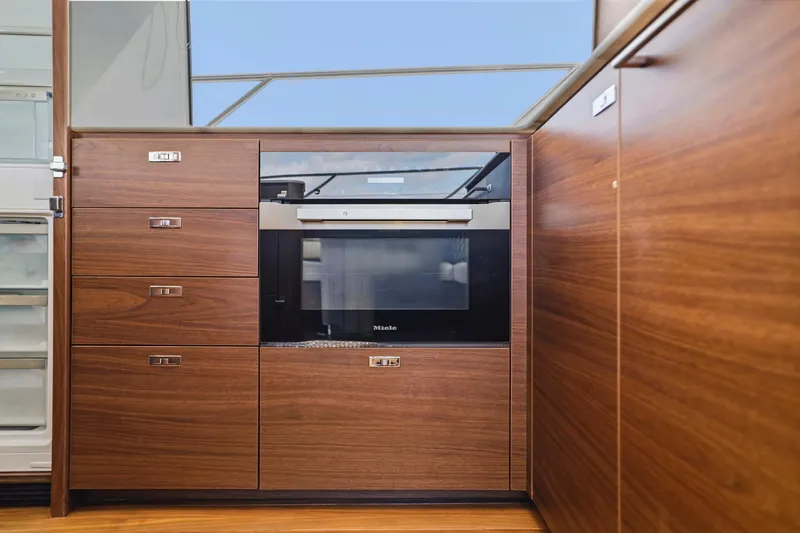 Slide: The Image of Modern kitchen interior in 2026 Princess F65 yacht with wood cabinetry and built-in appliances. - 39