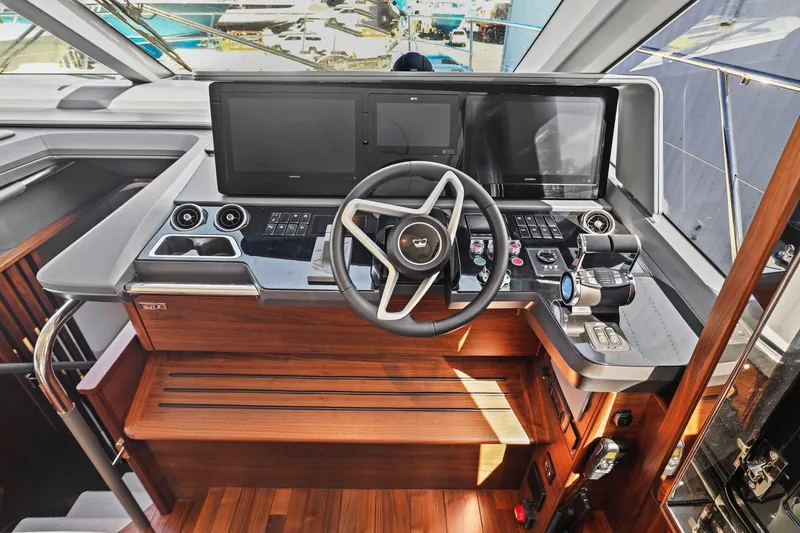 Slide: The Image of Helm of 2026 Princess F65 yacht with modern controls and wooden accents. - 46