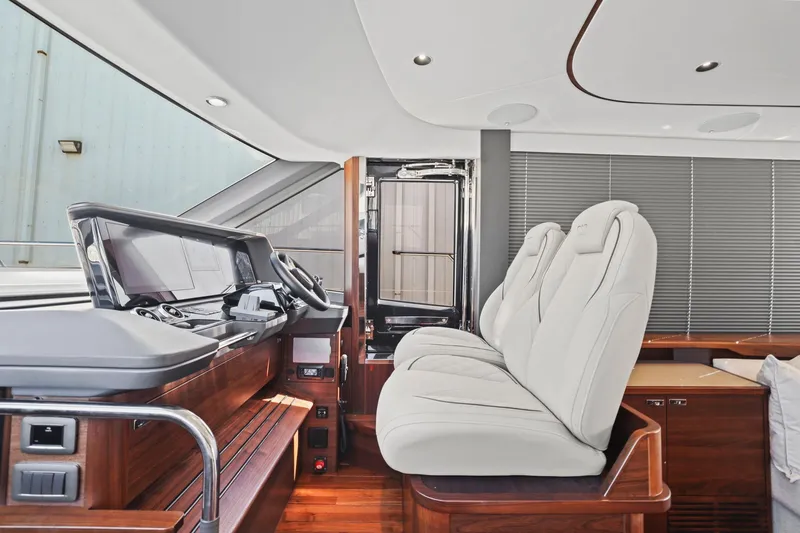 Slide: The Image of Luxurious interior of 2026 Princess F65 yacht with modern helm and plush seating. - 47
