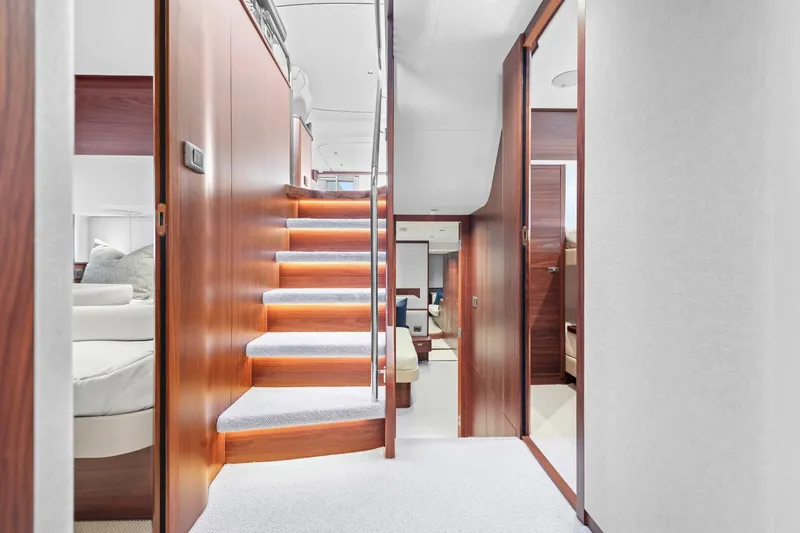 Slide: The Image of Luxurious interior of 2026 Princess F65 yacht with elegant wooden staircase. - 49