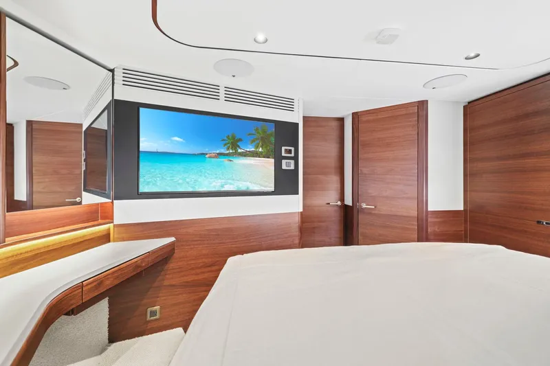 Slide: The Image of Luxurious interior of 2026 Princess F65 yacht with modern wood paneling and flat-screen TV. - 52