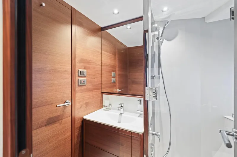 Slide: The Image of Luxurious bathroom in 2026 Princess F65 yacht with wood paneling and modern fixtures. - 58