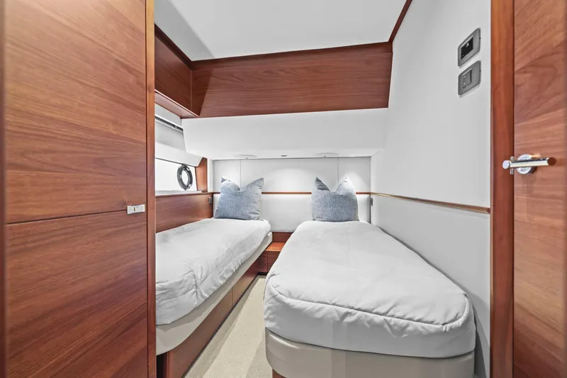 Slide: The Image of Luxurious twin cabin interior on 2026 Princess F65 yacht, featuring elegant wood finishes. - 60