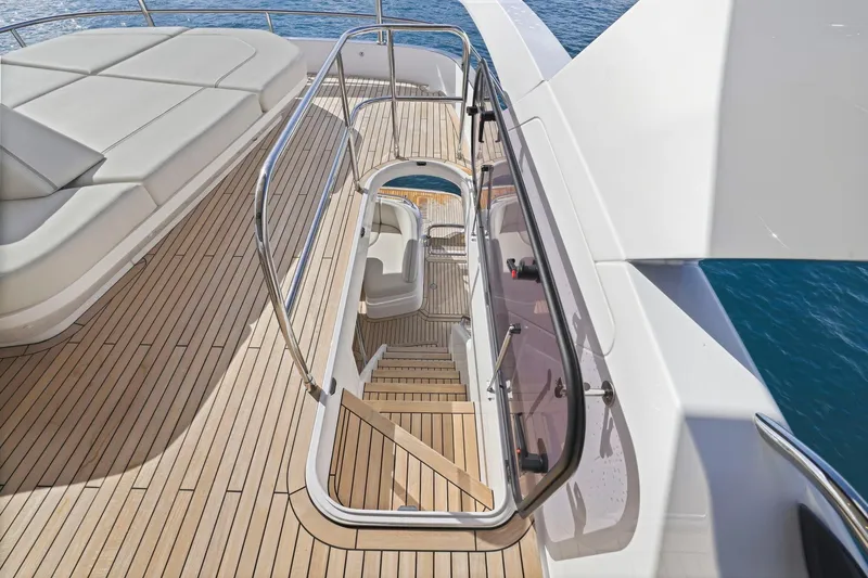 Slide: The Image of Luxurious 2026 Princess F65 yacht deck with elegant seating and sleek staircase. - 62