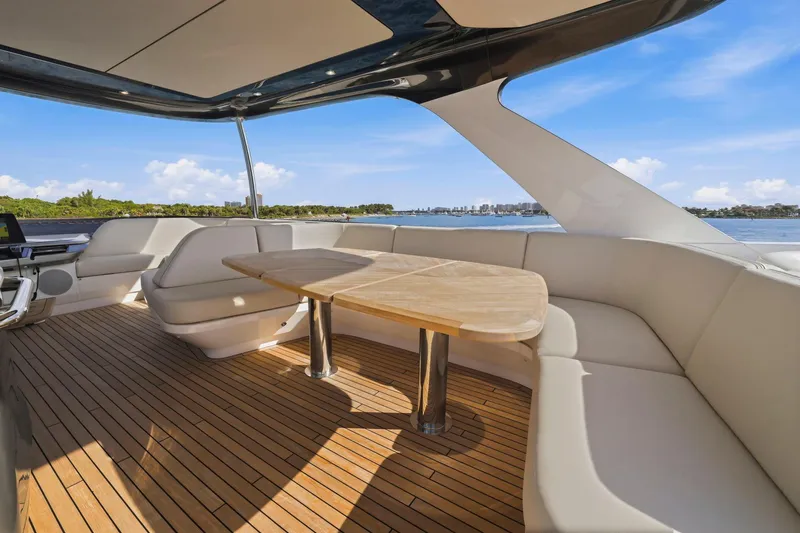 Slide: The Image of Luxurious 2026 Princess F65 yacht interior with elegant seating and wooden deck, overlooking serene waters. - 66