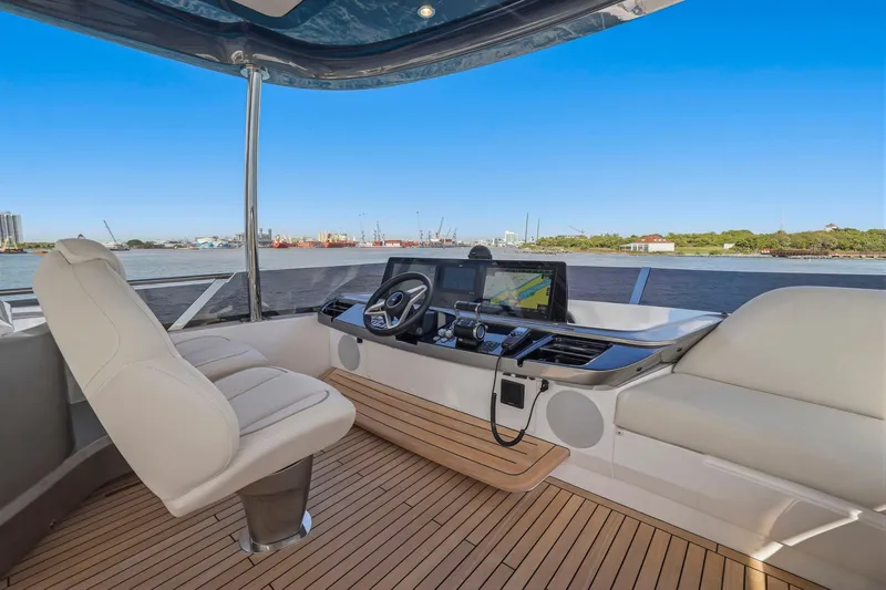 Slide: The Image of Luxurious 2026 Princess F65 yacht helm with modern navigation system and plush seating. - 70