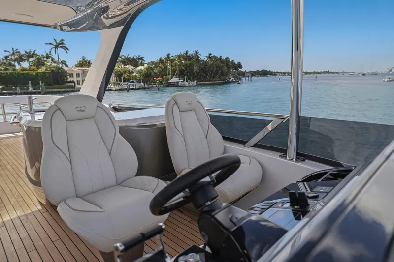 Slide: The Image of Luxury yacht Princess F65 cockpit with plush seating, overlooking serene waters. - 73