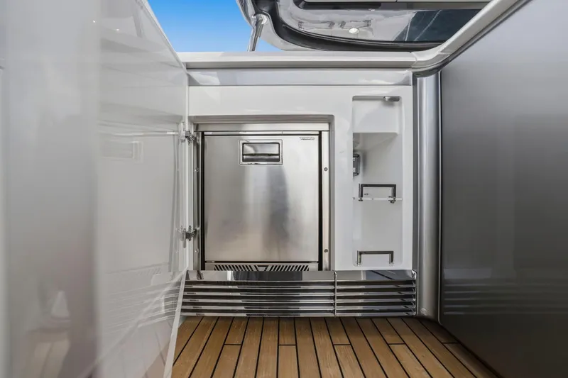 Slide: The Image of Luxurious 2026 Princess F65 yacht interior with sleek stainless steel appliances and wooden flooring. - 76