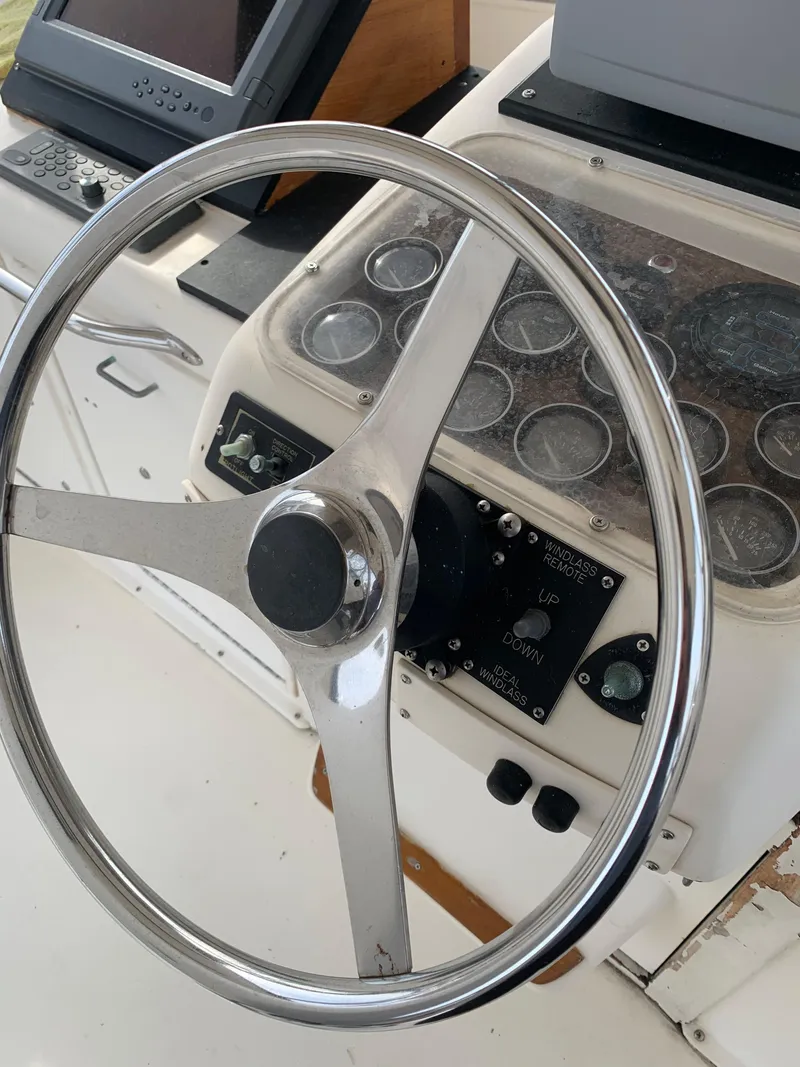 Slide: The Image of 1985 Ocean Yachts 55 Super Sport helm with steering wheel and navigation instruments. - 13