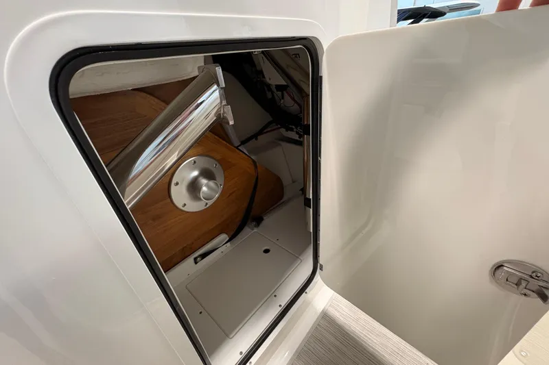 Slide: The Image of Storage compartment of 2026 Sea Ray SDX 230 boat, featuring sleek interior design. - 14