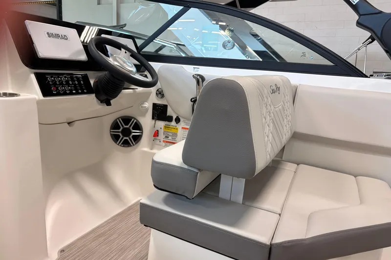 Slide: The Image of Interior of 2026 Sea Ray SDX 230 boat, featuring steering wheel and seating. - 9