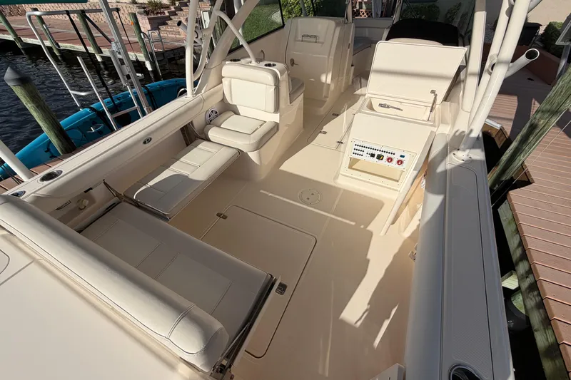 Slide: The Image of 2014 Pursuit DC 265 Dual Console boat interior with seating and control panel. - 9