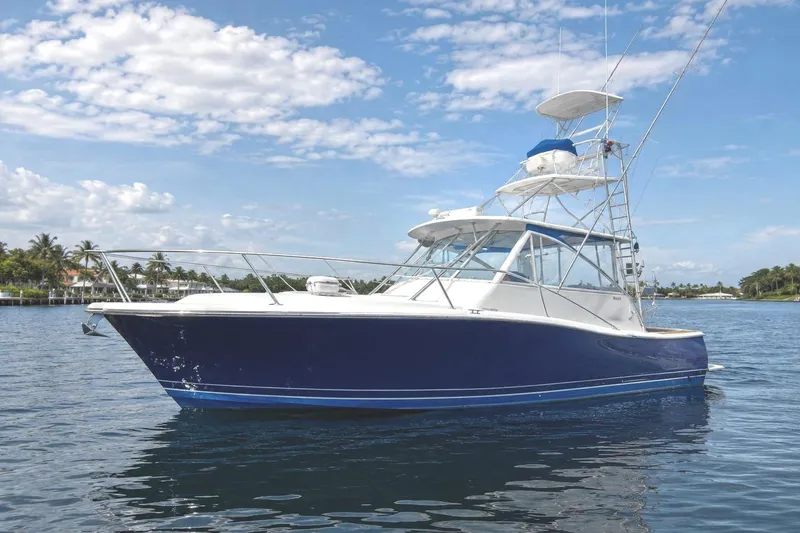 The Image of A blue and white 2008 Luhrs 41 Open boat on calm water under a blue sky. - 0