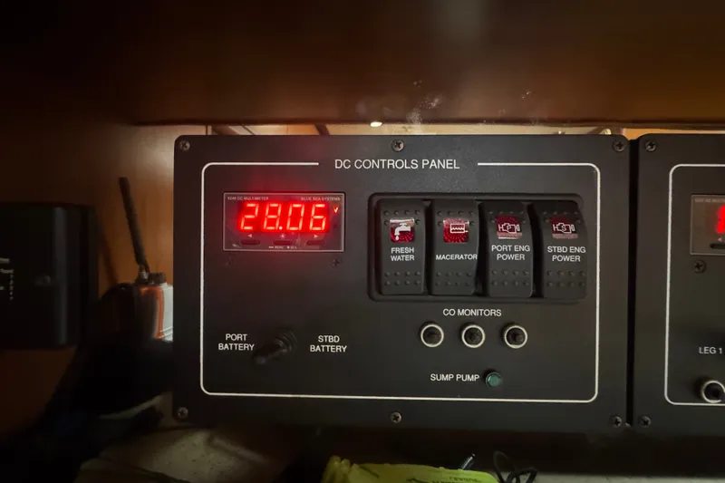 Slide: The Image of DC controls panel on a 2008 Luhrs 41 Open boat, displaying voltage and switches. - 82