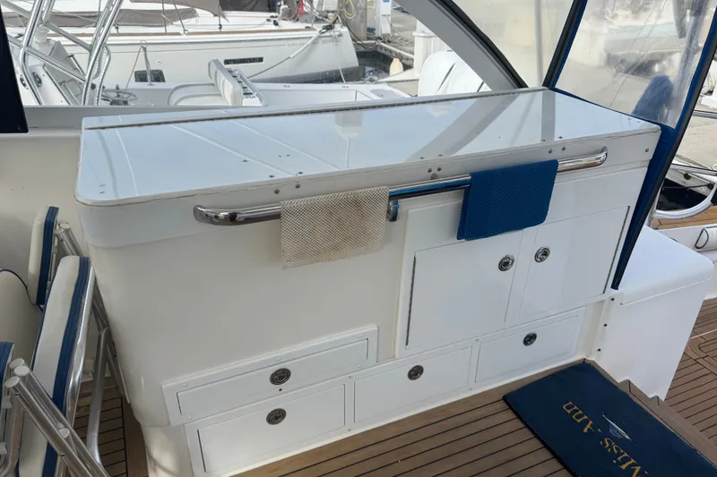 Slide: The Image of 2008 Luhrs 41 Open yacht interior with storage cabinets and towels on a rail. - 36