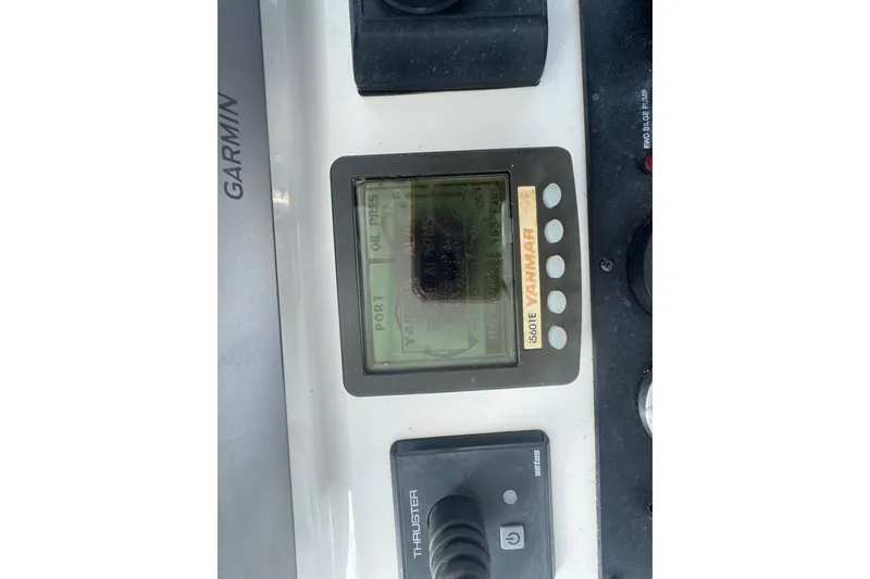 Slide: The Image of Control panel of a 2008 Luhrs 41 Open boat featuring Yanmar and Garmin displays. - 42