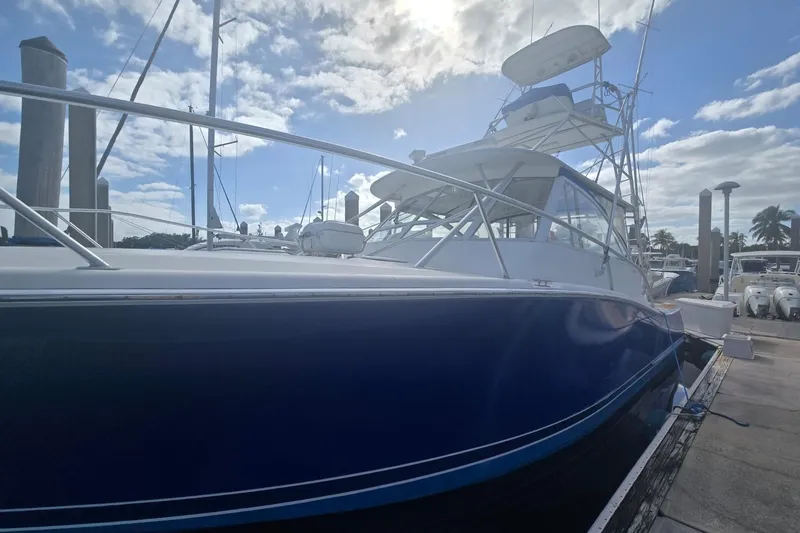 Slide: The Image of 2008 Luhrs 41 Open yacht docked under a partly cloudy sky. - 1
