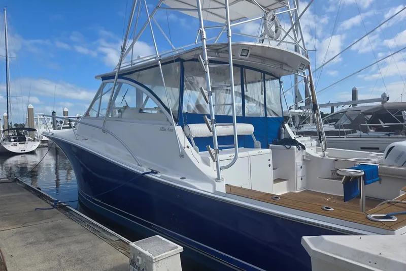 Slide: The Image of 2008 Luhrs 41 Open boat docked at marina under blue sky. - 2
