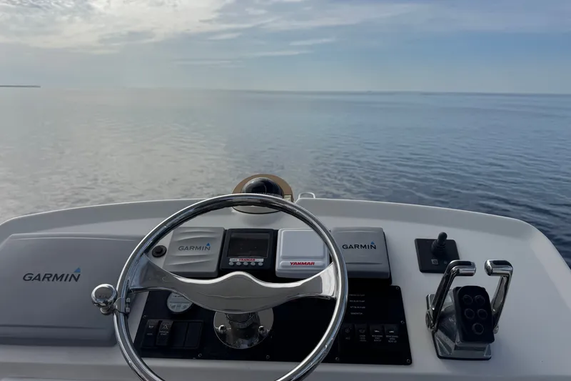 Slide: The Image of Helm of 2008 Luhrs 41 Open boat with Garmin navigation, overlooking calm sea. - 61