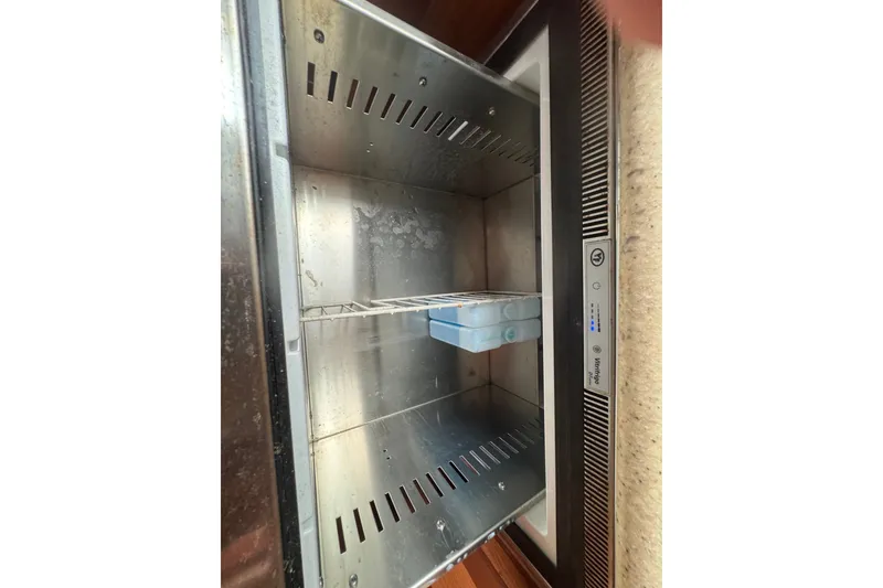 Slide: The Image of Empty stainless steel refrigerator interior on a 2008 Luhrs 41 Open boat. - 89
