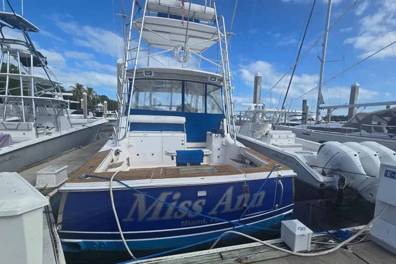 Slide: The Image of 2008 Luhrs 41 Open boat docked, featuring "Miss Ann" name, blue accents, and marina setting. - 3