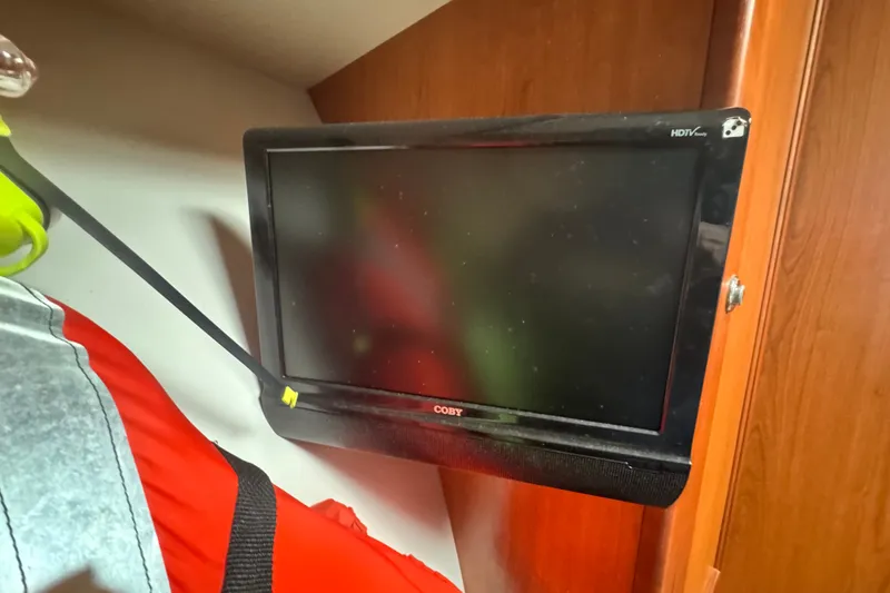 Slide: The Image of Flat-screen TV mounted in a 2008 Luhrs 41 Open boat interior. - 68